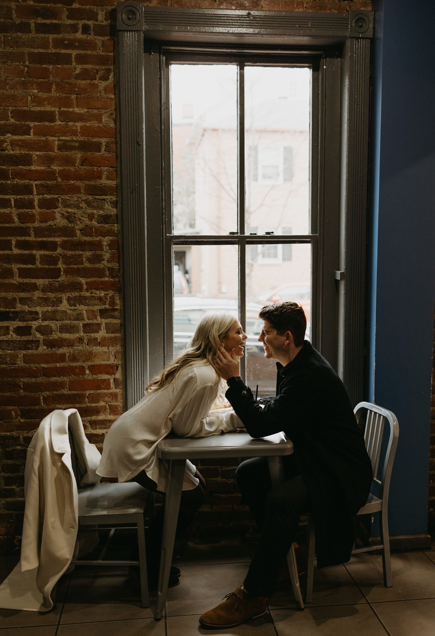 couple kissing at coffee shop