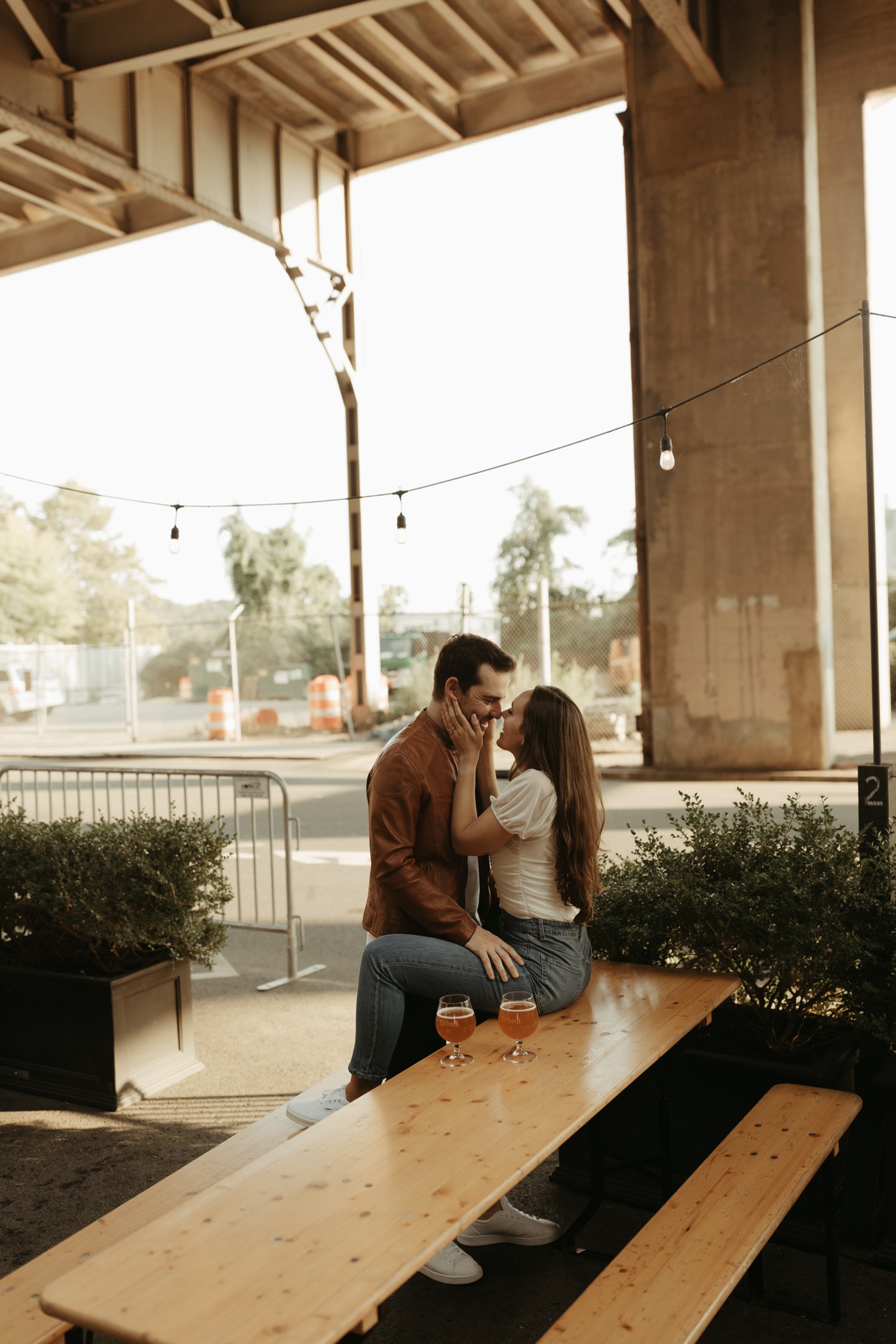 couple drinking beers for engagement photos