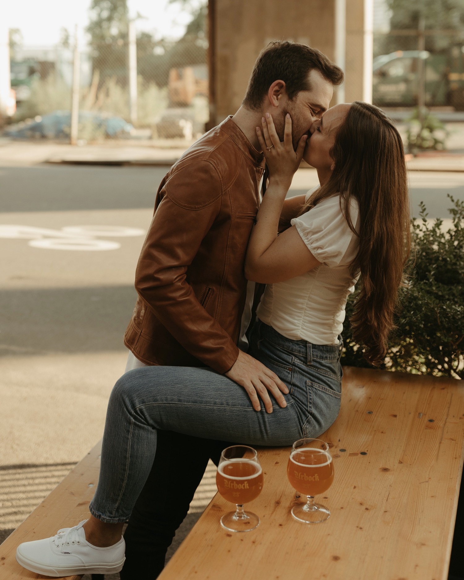 couple drinking beers for engagement photos