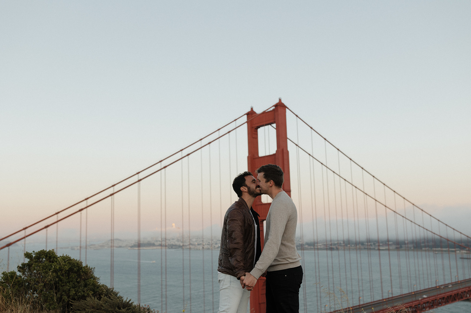 LGBTQ Couple embracing with Golden Gate Bridge in background