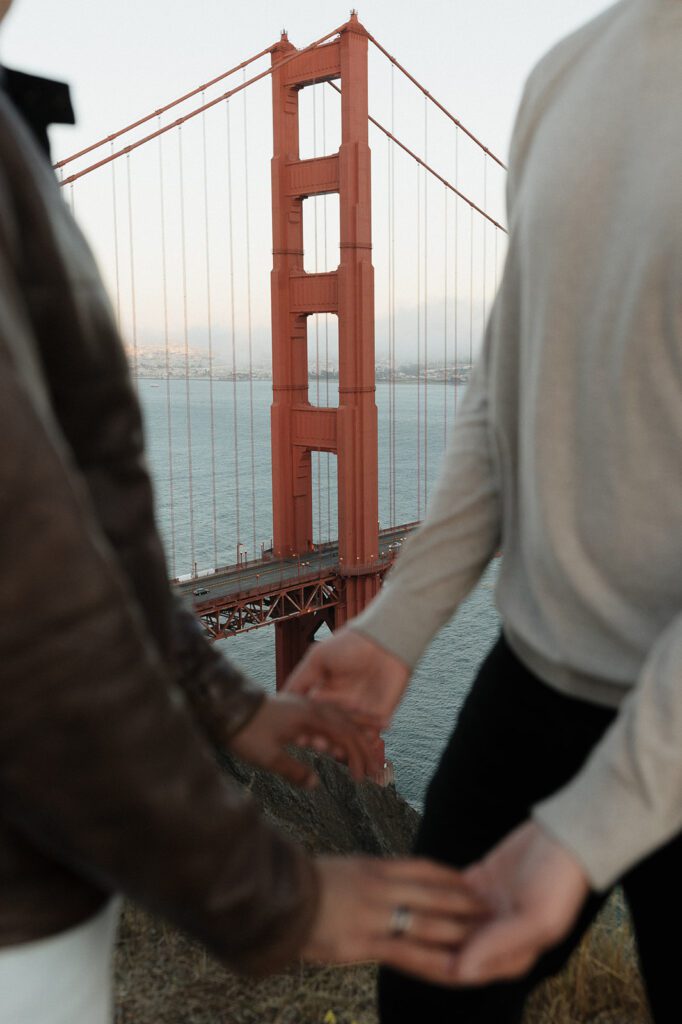 LGBTQ Couple embracing with Golden Gate Bridge in background