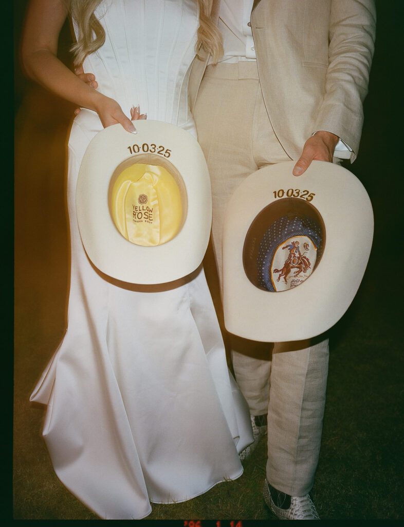 Bride and grooms cowboy hats.