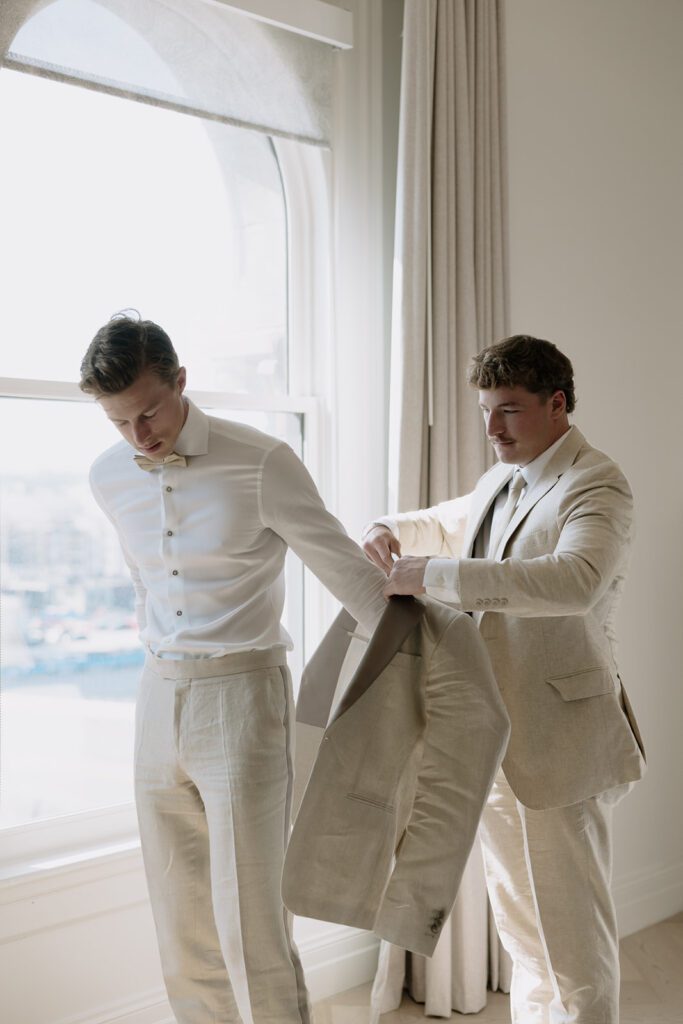 A groom and his brother getting ready on his wedding day.