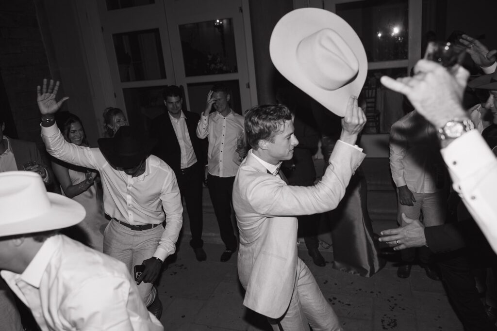 Groom and guests dancing on their wedding day.