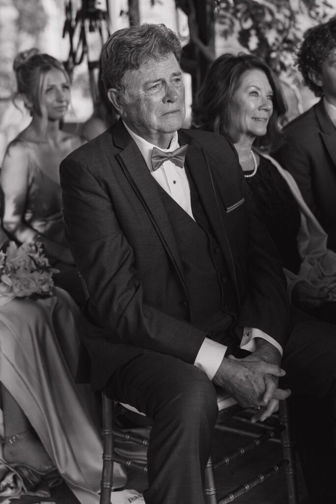 A man crying during the wedding ceremony.