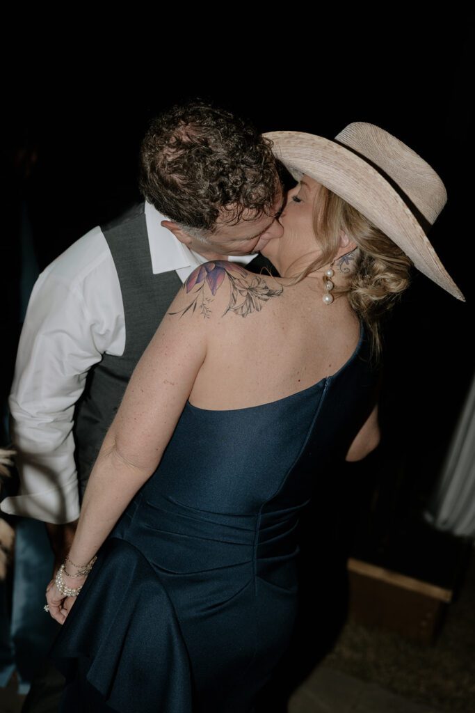 Guests kissing at a wedding.