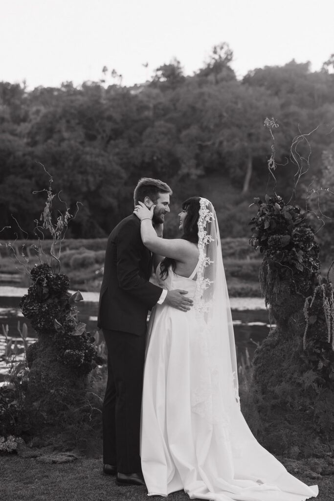 Bride and groom kissing at wedding ceremony