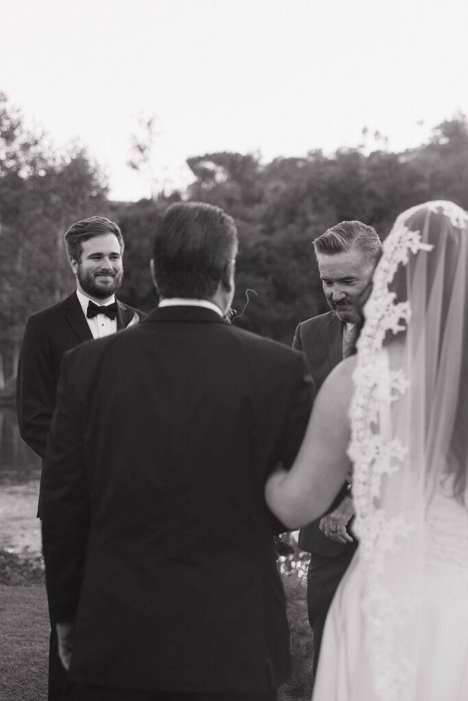 Groom looking at bride during wedding ceremony