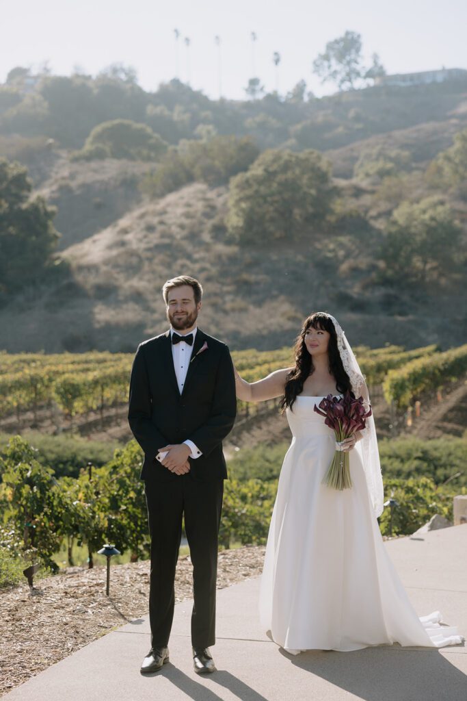 Bride walking up for first look at Monserate Winery wedding in Fallbrook California